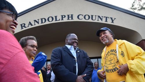 Edward DuBose (center) with the NAACP and other supporters celebrate outside the Randolph County Government Center in August after the Board of Elections defeated a contentious proposal to close seven rural voting locations. The board voted 2-0 to save the precincts and preserve easy access to the polls for about 1,700 registered voters. HYOSUB SHIN / HSHIN@AJC.COM