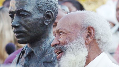 James Meredith, who integrated the University of Mississippi on Oct. 1, 1962, stands next to a statue of himself during a dedication ceremony of a civil rights monument in Oxford, Miss., on Oct. 1, 2006. (AP Photo/Oxford Eagle, Bruce Newman)