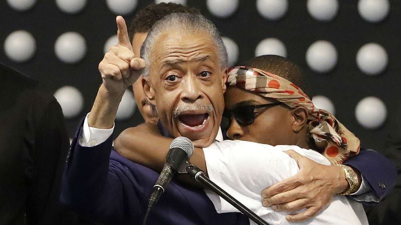 Rev. Al Sharpton, left, hugs Stevante Clark while speaking during the funeral services for Clark's brother, Stephon, Thursday, March 29, 2018, at Bayside of South Sacramento Church. Stephon Clark, 22, was killed March 18 after two Sacramento police officers fired 20 shots at him as he stood on his grandparents' back patio. Clark, a father of two small boys, was unarmed.