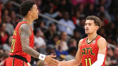 Atlanta Hawks guard Trae Young gets five from John Collins in the final minutes of a 106-82 victory over the Miami Heat in a NBA basketball game at State Farm Arena on Sunday,  Jan. 6, 2019, in Atlanta.   Curtis Compton/ccompton@ajc.com