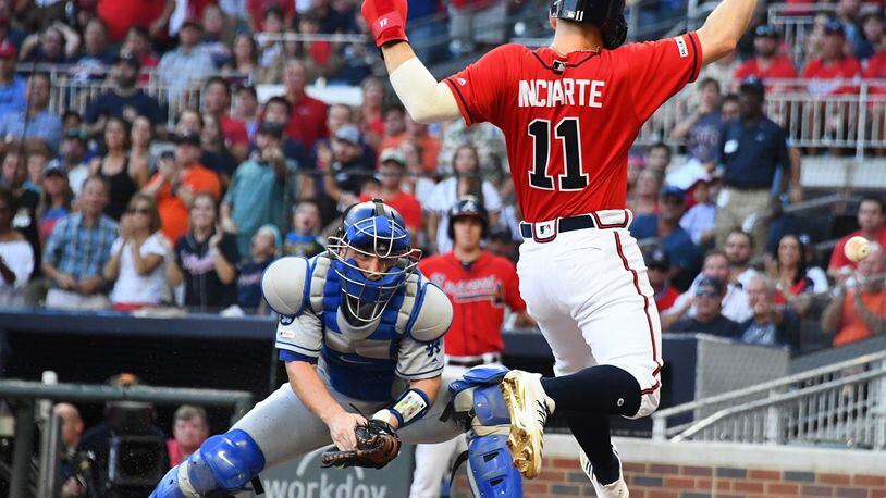 Ender Inciarte of the Braves scores a second-inning run but was hurt on the play. (Photo by Scott Cunningham/Getty Images)