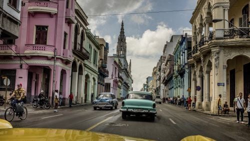 FILE â Vintage cars cruise a street in Havana, Cuba, Jan. 2016. The author Reif Larsen says âNo one can predict what will happen to Cuba in the coming years, which is why you must rush there now. As in, right now.â (Tomas Munita/The New York Times) -- NO SALES