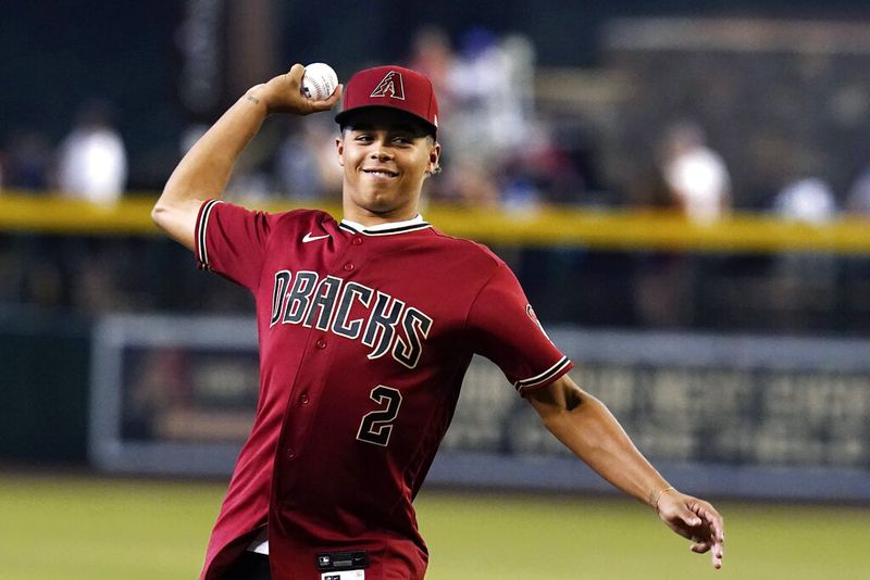 Arizona Diamondbacks first round MLB draft pick Druw Jones throws out the first pitch prior to a baseball game against the Washington Nationals Saturday, July 23, 2022, in Phoenix. (AP Photo/Ross D. Franklin)