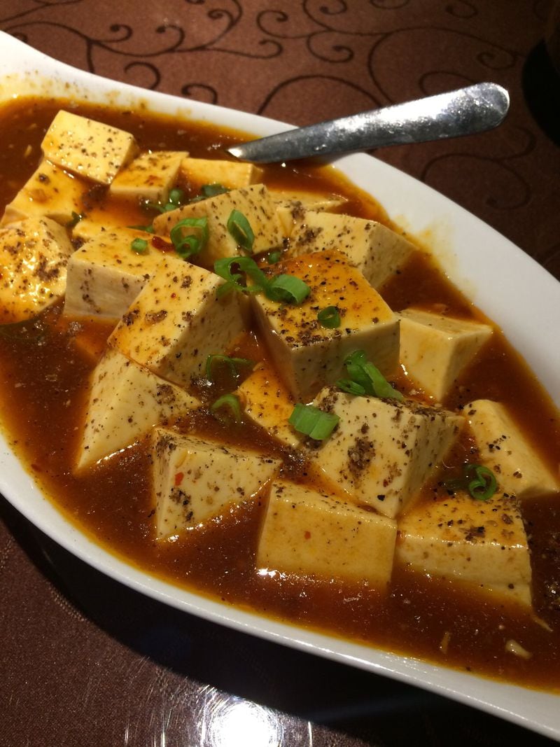 The mapo tofu at Yummy Spicy on Buford Highway sports unusually large cubes of tofu in a fiery sauce seasoned with pork and Sichuan peppercorns. CONTRIBUTED BY WENDELL BROCK