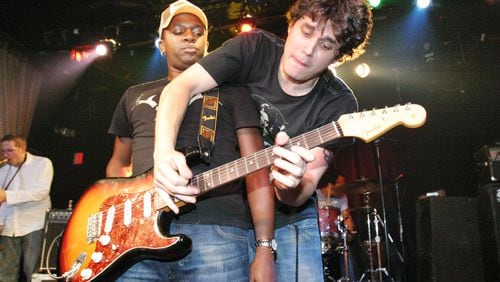 John Mayer offers an assist to David Ryan Harris at Smith's Olde Bar in this file photo. Robb Cohen Photography & Video/www.RobbsPhotos.com. Go here to read our Personal Journey marking Robb Cohen's 1000th concert shoot for the AJC, and see hundreds of photos from our archive.