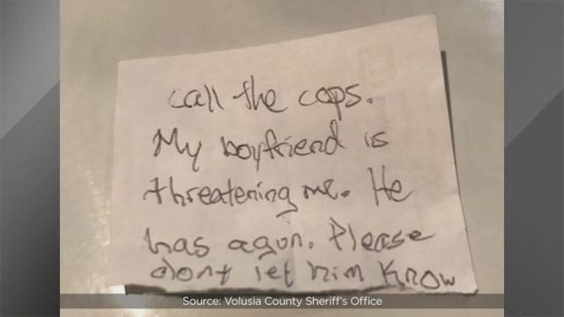 A note given to staff at an animal hospital by a woman being held captive by her boyfriend, deputies said. (Photo: Volusia County Sheriff's Office)