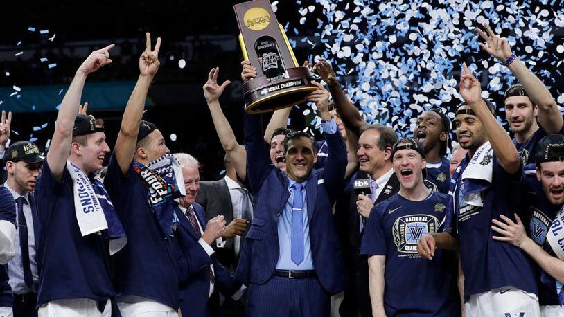 Villanova head coach Jay Wright, center, celebrates with his team after beating Michigan 79-62 in the championship game of the Final Four NCAA college basketball tournament, Monday, April 2, 2018, in San Antonio. (AP Photo/David J. Phillip)