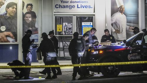 Atlanta police officers investigate the scene where a man was shot dead about 3:30 a.m. outside a Goodwill donation center on Collier Road on Tuesday morning, Oct. 20, 2020. . (John Spink / John.Spink@ajc.com)