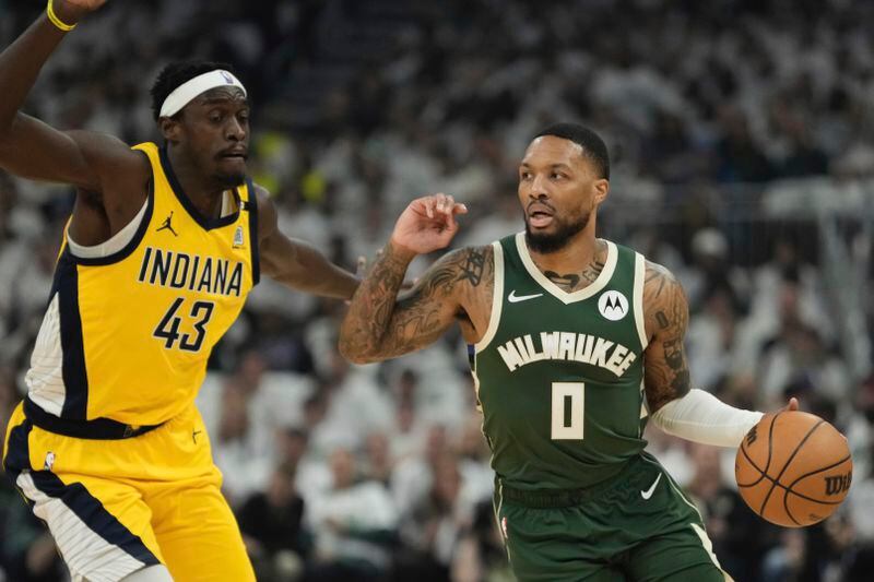Milwaukee Bucks' Damian Lillard gets past Indiana Pacers' Pascal Siakam during the first half of Game 2 of the NBA playoff basketball game Tuesday, April 23, 2024, in Milwaukee. (AP Photo/Morry Gash)