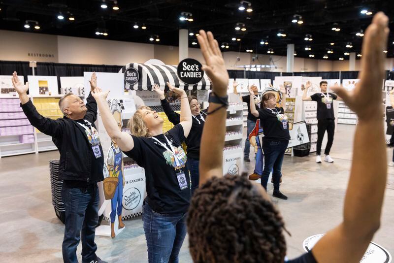 See's Candies associates, including Holly Pellicano of San Francisco, center, do yoga together before shareholders arrive for the Berkshire Hathaway annual meeting on Saturday, May 4, 2024, in Omaha, Neb. (AP Photo/Rebecca S. Gratz)