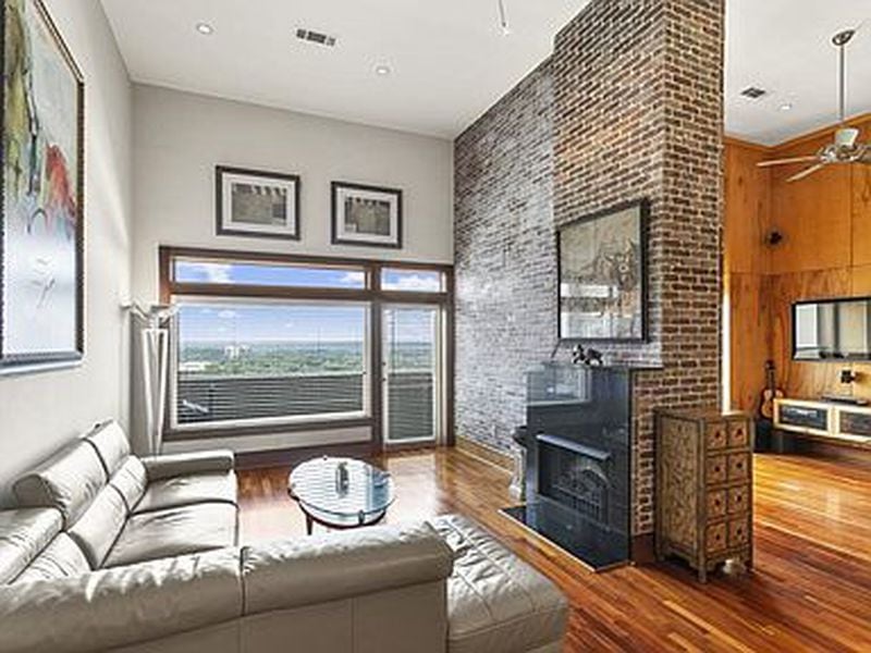 The living room's custom brick accent wall are among the condo's luxury upgrades.