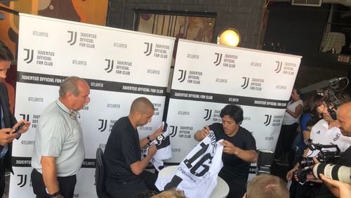 Juventus legends David Trezeguet and Mauro Camoranesi sign autographs for fans at the opening of the Juventus fan club.