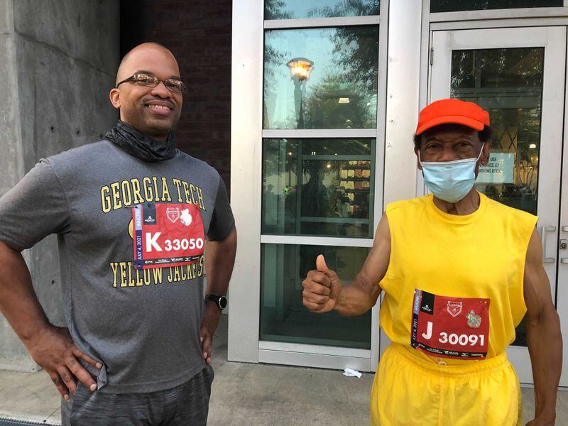 Paul Simpson, 79 (right), of Atlanta struck up a conversation with fellow runner Beniquez Jones, 46, of Stone Mountain while they waited to start the race. They bonded over both being Georgia Tech graduates and running the race again in person. (Photo: Helena Oliviero/AJC)