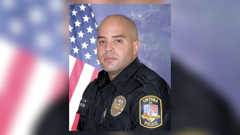 Officer Christopher Ewing was killed in a crash late Monday off South Cobb Drive.