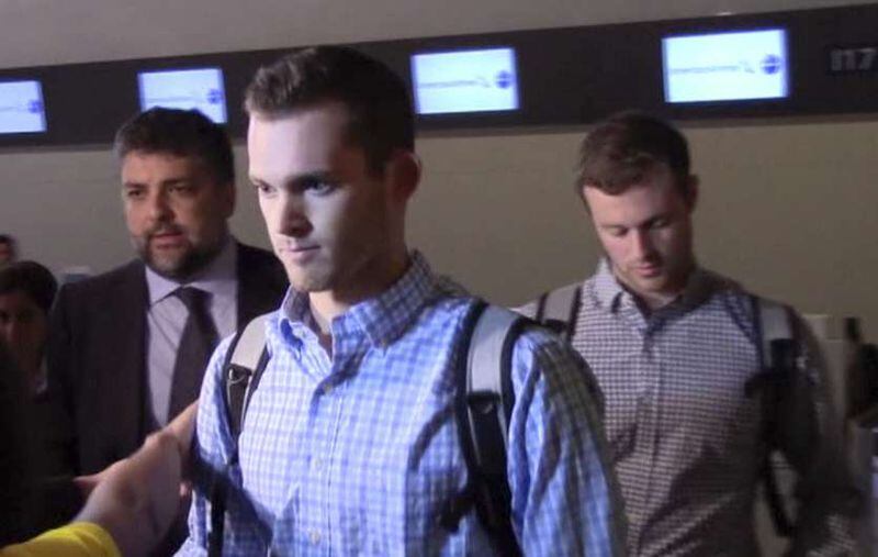 In this image made from video, American Olympic swimmers Gunnar Bentz and Jack Conger walk in the departure area after checking into their flight at the airport in Rio de Janeiro, Brazil on Thursday, Aug. 18, 2016. AP Photo