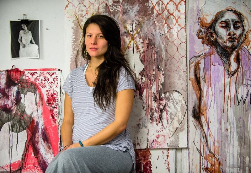 Jessica Caldas sits in her studio at Georgia State University, surrounded by her work inspired by (from bottom right) her experience and recovery from sexual assault, the general experience of growing up as a woman, and domestic violence, Wednesday, Oct. 25, 2017.    Jessica posted #MeToo but had mixed feelings about it. She is a local artist and rape victim. She said it's important to raise awareness to the problem of sexual harassment and sexual assault, but said she would really like to see actions being taken to lead to real change.    BITA HONARVAR/SPECIAL