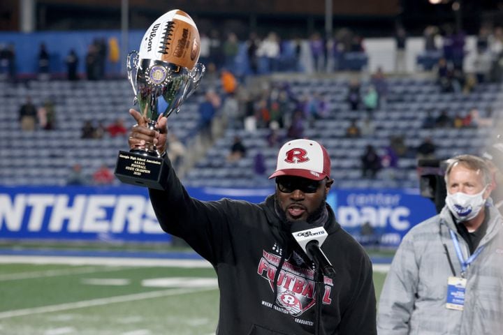 Warner Robins coach Marquis Westbrook celebrates with the trophy after their 62-28 win against against Cartersville in the Class 5A state high school football final at Center Parc Stadium Wednesday, December 30, 2020 in Atlanta. JASON GETZ FOR THE ATLANTA JOURNAL-CONSTITUTION