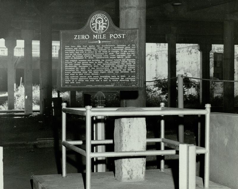 The Zero Mile Post is shown with a brand new historic marker in this photo from 1958. The landmark used to be exposed beneath a downtown viaduct and was open to the public. Today, it sits inslide a government building that remains locked. (AJC Archive at GSU Library / AJCP142-020I)