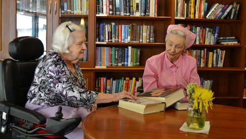 Jane Williams and Joan Lazarchik, residents at Wesley Woods Towers, in the library of the older adult community  on Clifton Road in Atlanta. Both women rely on gifts from donors to the benevolence care program of Wesley Woods to help pay for their stay at the Towers. United Methodist churches across north Georgia will collect a special Wesley Woods Sunday offering on Mother's Day