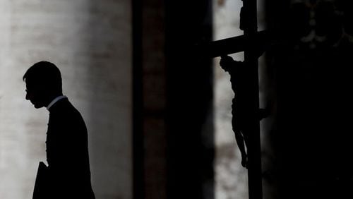 A priest i silhouetted during Pope Francis general weekly audience in St. Peter's Square at the Vatican. (Photo by Alessandra Benedetti/Corbis via Getty Images)
