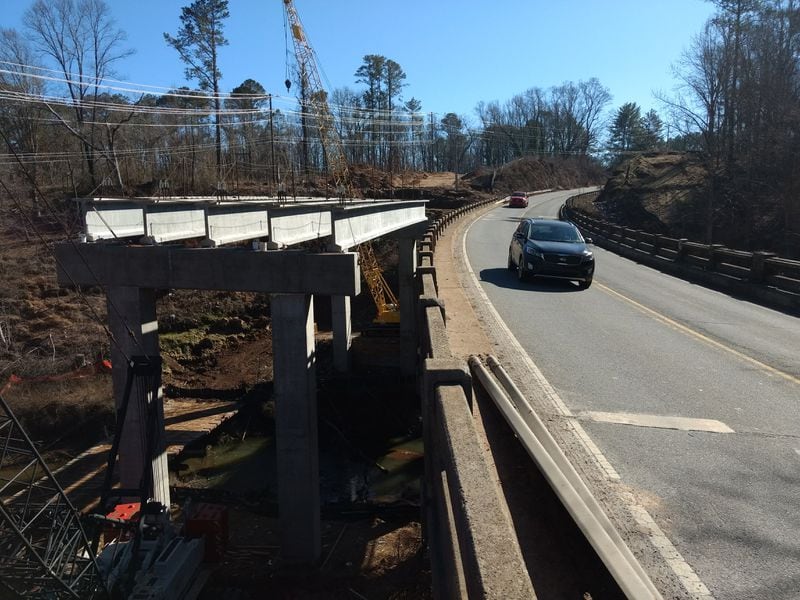 The new bridge over the Little River on Ga. 140 / Arnold Mill Road will be higher off the ground, with less of a downhill grade than the current bridge. It's also wider, with room for 10-foot shoulders on either side of the two traffic lanes. (Brian O'Shea / bposhea@ajc.com)