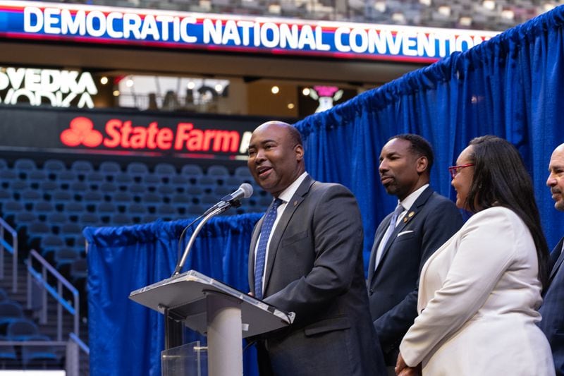 Democratic National Committee Chair Jaime Harrison, from left, Atlanta Mayor Andre Dickens  and Rep. Nikema Williams speak to journalists after touring State Farm Arena on July28, 2022, as part of Atlanta’s bid to host the 2024 Democratic National Convention. (Ben Gray for the Atlanta Journal-Constitution)