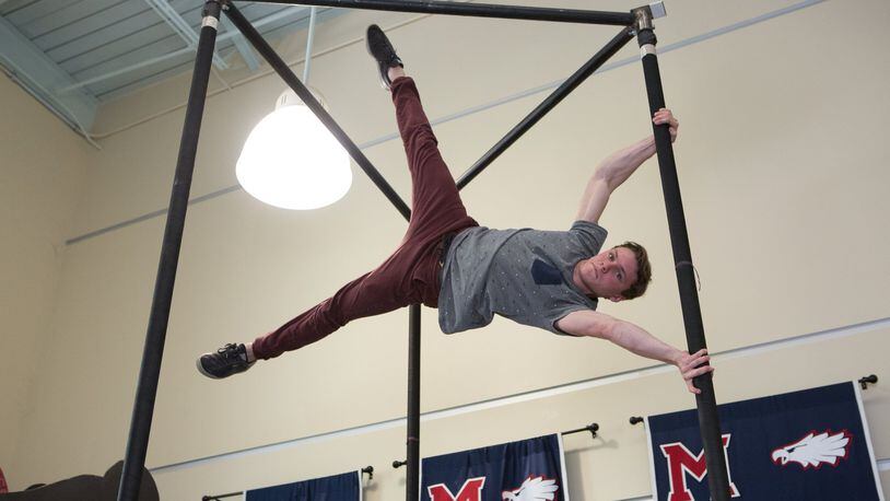 Milton High School student Cole Dobbs performs a move call the “human flag” on Chinese poles in a unique Milton High School class inspired by Cirque du Soleil. (Photo by Phil Skinner)