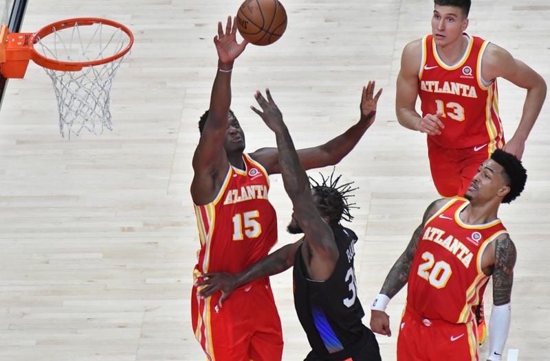 Hawks center Clint Capela (15) blocks a shot by New York Knicks forward Julius Randle (30) during the second half of Game 3 of their first-round playoff series Friday, May 28, 2021, at State Farm Arena in Atlanta. (Hyosub Shin / Hyosub.Shin@ajc.com)
