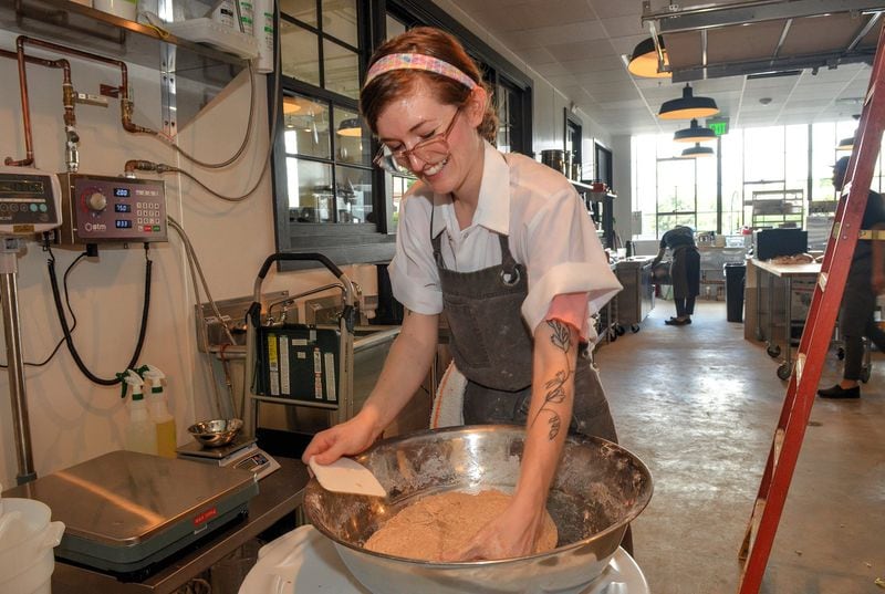 Head baker Anna Morris kneads whole wheat dough in the kitchen of Root Baking Co. Morris transplanted to Atlanta with the company when it moved from Charleston, S.C. CONTRIBUTED BY CHRIS HUNT / SPECIAL