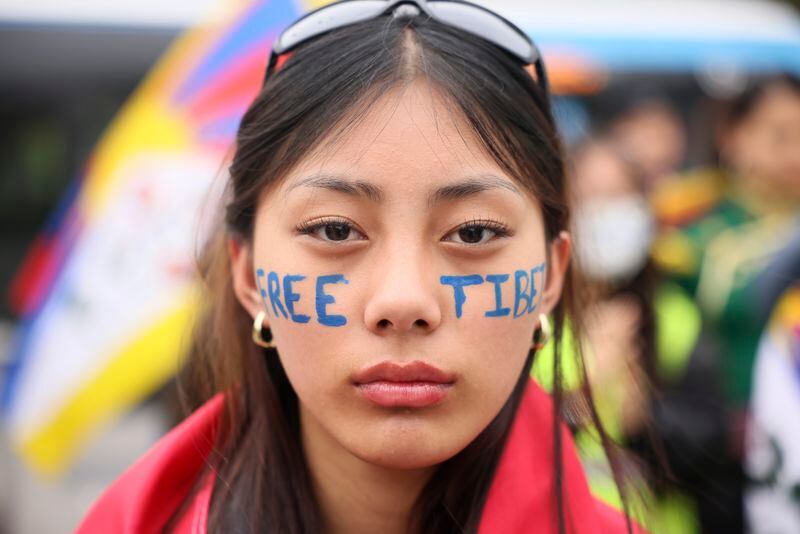 A Tibetan woman demonstrates Sunday, May 5, 2024 in Paris. French President Emmanuel Macron is welcoming China's Xi Jinping for a two-day state visit to France. The state visit marks the 60th anniversary of diplomatic relations between the two countries and follows Macron's trip to China in April 2023. (AP Photo/Thomas Padilla)