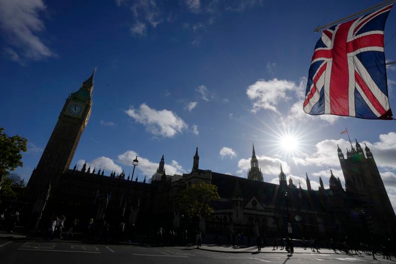 FILE - The Union flag flaps in the wind outside the Houses of Parliament in London, Monday, Oct. 24, 2022. Britain’s governing Conservative Party said Thursday, April 18, 2024, it has suspended a lawmaker who is alleged to have used campaign funds for personal medical expenses and to pay off someone who was threatening him. The case is the latest allegation of sleaze to hit the Conservatives, who have lost several lawmakers to ethics scandals in the past two years – including former Prime Minister Boris Johnson. (AP Photo/Kirsty Wigglesworth, file)