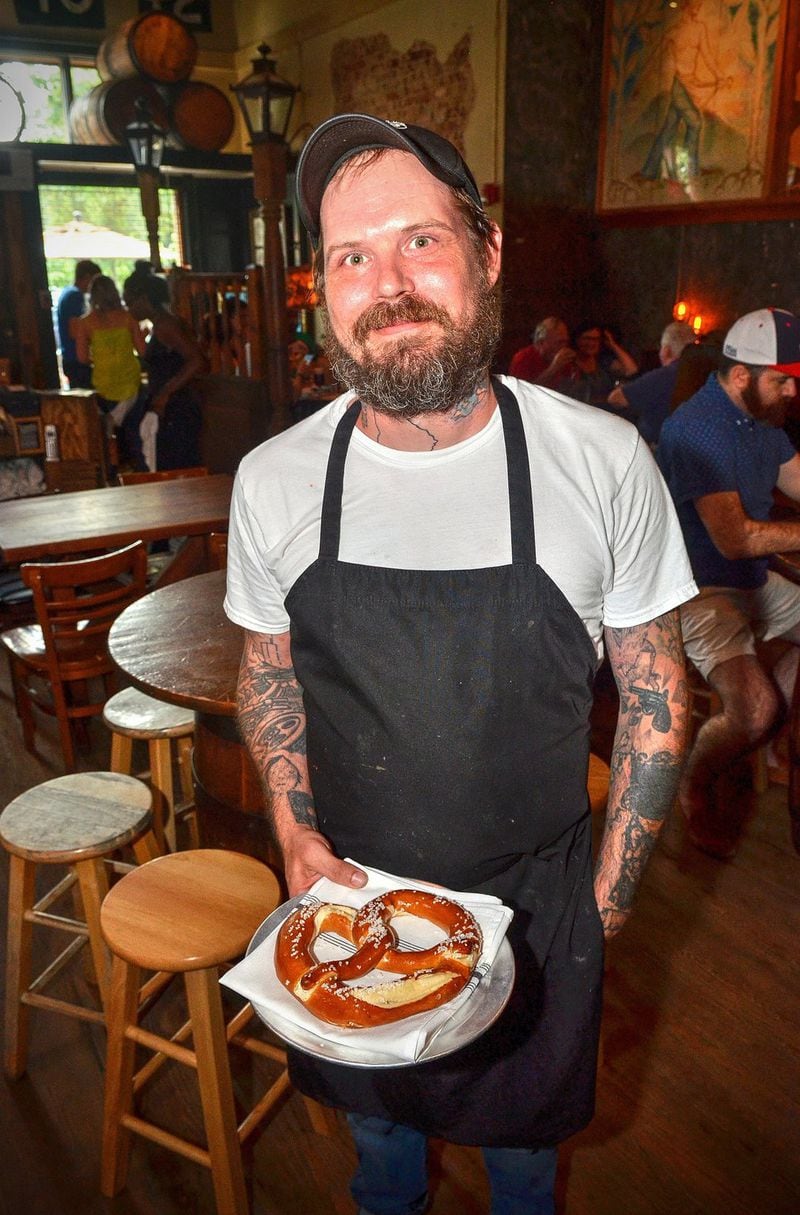 Ryan Tittle, chef at the Brick Store Pub for 14 years, poses for a brief photo during a pre-happy hour Friday. Mike Gallagher, one of the three men who founded the Brick Store Pub in 1997, said, “The reason that Brick Store is at the level it’s at and is still present and important and of the moment is because of the people working here. It’s the chefs and servers who make it happen every day.” CHRIS HUNT / SPECIAL