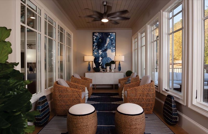 A blue and white area rug was chosen to bring color into the sunroom.
