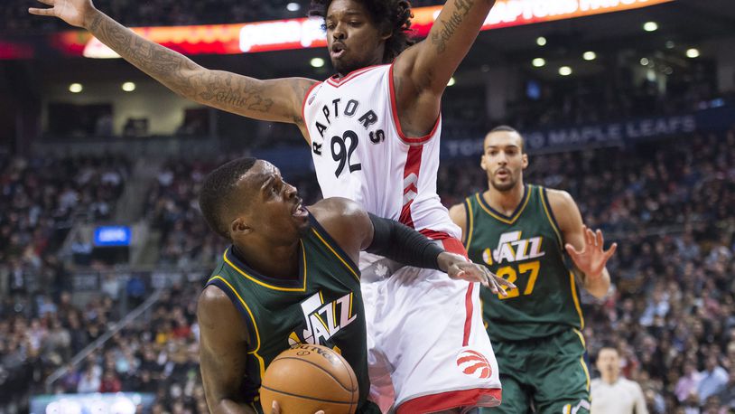 Toronto Raptors center Lucas Nogueira (92) defends against Utah Jazz guard Shelvin Mack (8) during the first half of an NBA basketball game, Wednesday, March 2, 2016 in Toronto. (Nathan Denette/The Canadian Press via AP) MANDATORY CREDIT