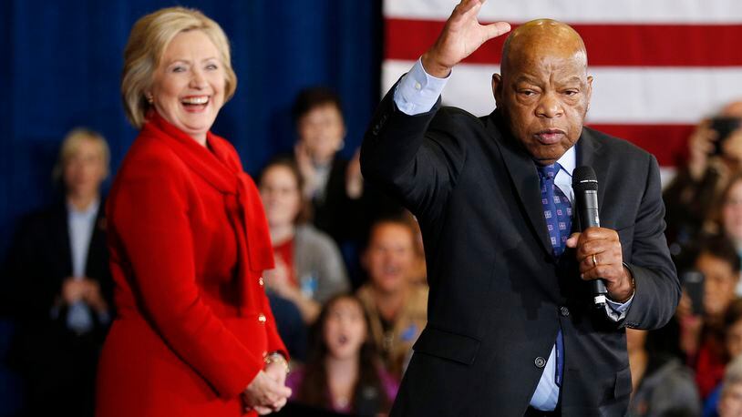 Democratic presidential candidate Hillary Clinton takes the stage with U.S. Rep. John Lewis, D-Ga., right, during a rally Sunday in Las Vegas. AP/John Locher