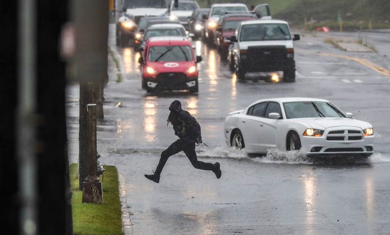 Motorists and pedestrians dodged standing water along Northside Drive near 14th Street in Atlanta as Tropical Depression Fred made its way through North Georgia on Tuesday morning.