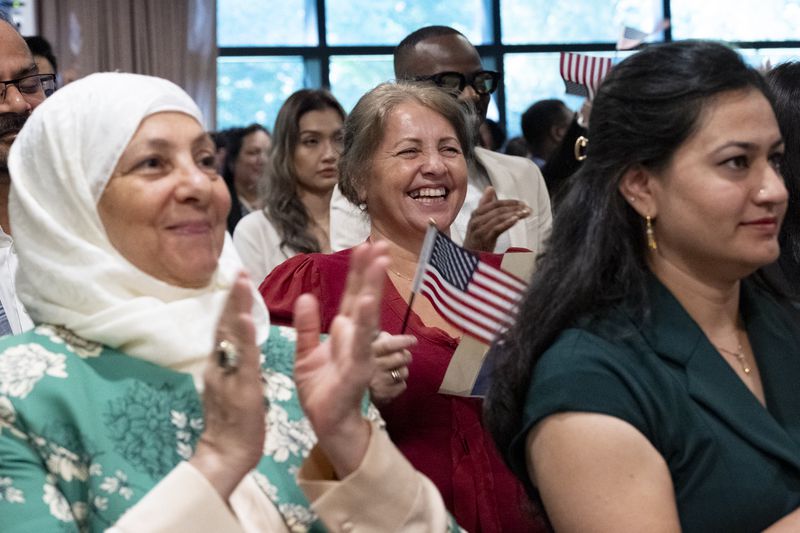 Sefika Dizdarevic, from Bosnia and Herzegovina, can’t hold back her joy as she is sworn in as a naturalized citizen during a ceremony at The Carter Center in Atlanta on Sunday, Oct. 1, 2023. The ceremony was held at the center in honor of President Jimmy Carter’s 99th birthday.   (Ben Gray / Ben@BenGray.com)