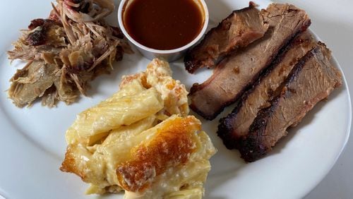 This order from Dave Poe's BBQ in Marietta includes pork, beef brisket and baked macaroni and cheese. Bob Townsend for The Atlanta Journal-Constitution