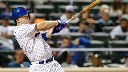 New York Mets' David Wright hits a seventh-inning, RBI, ground-rule double in a baseball game against the Miami Marlins in New York, Monday, Sept. 14, 2015. (AP Photo/Kathy Willens)