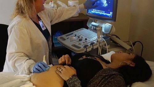 Perin Stowers (left) performs an ultrasound on patient Yenni Ortiz at the Hall County Health Department in Gainesville. (Photo by Phil Skinner)