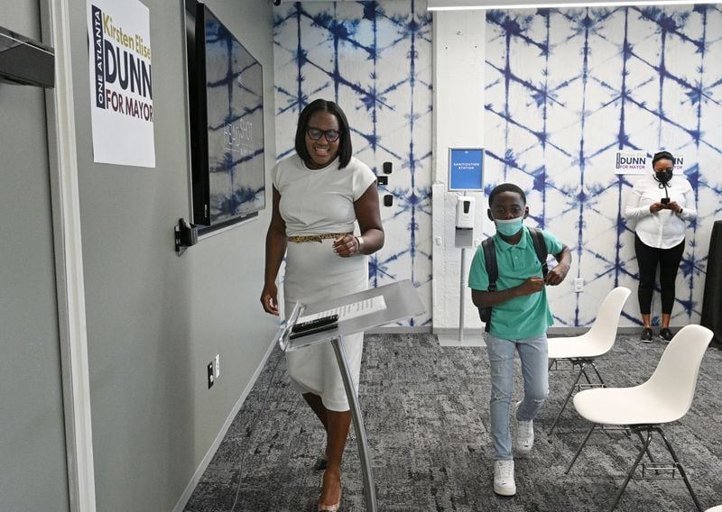August 25, 2021 Atlanta - Local businesswoman Kirsten Dunn with her son Joshua walks to the podium to officially announce her candidacy to become Atlanta's 61st mayor at The Gathering Spot in Atlanta on Wednesday, August 25, 2021. (Hyosub Shin / Hyosub.Shin@ajc.com)