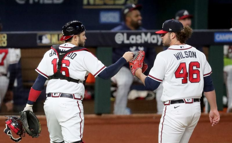 Braves starting pitcher Bryse Wilson (46) gets a fist-bump from catcher Travis d'Arnaud following the second inning against the Los Angeles Dodgers in NLCS Game 4 Thursday, Oct. 15, 2020, at Globe Life Field in Arlington, Texas. (Curtis Compton / Curtis.Compton@ajc.com)



