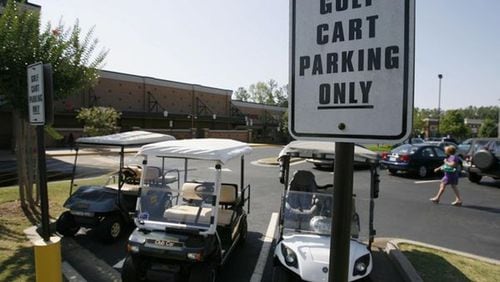 Two Cherokee County homeowners associations are seeking designations as “Motorized Cart Districts” where golf carts can legally operate on the street. AJC FILE