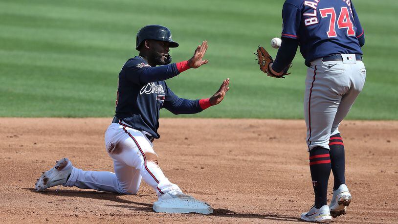 Atlanta Braves' Guillermo Heredia calls time after stealing second base past Minnesota Twins second baseman Travis Blankenhorn during the third inning Friday, March 5, 2021, at CoolToday Park in North Port, Fla. (Curtis Compton / Curtis.Compton@ajc.com)