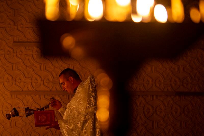 Priest Ivan, chaplain of the 72nd Separate Mechanized Brigade of the Ukrainian army, leads a Christian Orthodox Easter religious service, in Donetsk region, Ukraine, Saturday, May 4, 2024. (AP Photo/Francisco Seco)