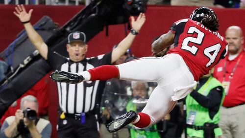 Falcons running back Devonta Freeman flies high as he scores against the Patriots during the first half.  The Atlanta Falcons lost to the New England Patriots in overtime, 34-28, in Super Bowl LI at NRG Stadium in Houston, TX, Sunday,  February 5, 2017. Bob Andres/AJC