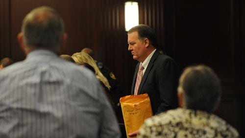 Michael Dunn enters the courtroom as his parents, Phillip and Sandra Dunn look on, as the day's proceedings begin. The retrial of Michael Dunn on murder charges for the shooting death of 17-year old Jordan Davis in a dispute over loud music at at Jacksonville gas station in November of 2012 continued Wednesday with jury instructions and deliberation. Judge Russell Healey presided over the trial held in his courtroom in the Duval County Courthouse in Jacksonville, FL on Oct. 1, 2014.