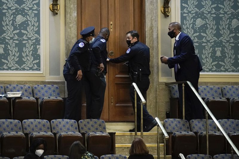 U.S. Capitol Police secure a door as rioters try to break into the House chamber Jan. 6. (J. Scott Applewhite/AP file photo)