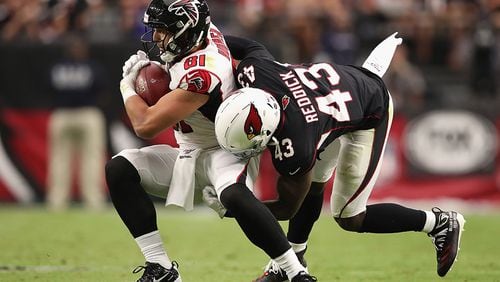 Falcons tight end Austin Hooper makes a reception against Cardinals' outside linebacker Haason Reddick during the second half Oct. 13, 2019,  at State Farm Stadium in Glendale, Ariz.