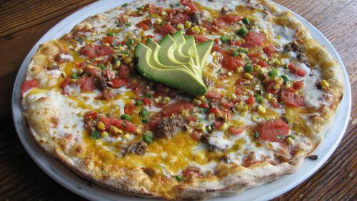 The spicy Mayan pizza at Fire Stone Wood Fired Pizza & Grill in Woodstock offers south of the border flavors like a poblano salsa, smoked shredded beef and corn pico. Photo: Fire Stone Wood Fired Pizza & Grill.